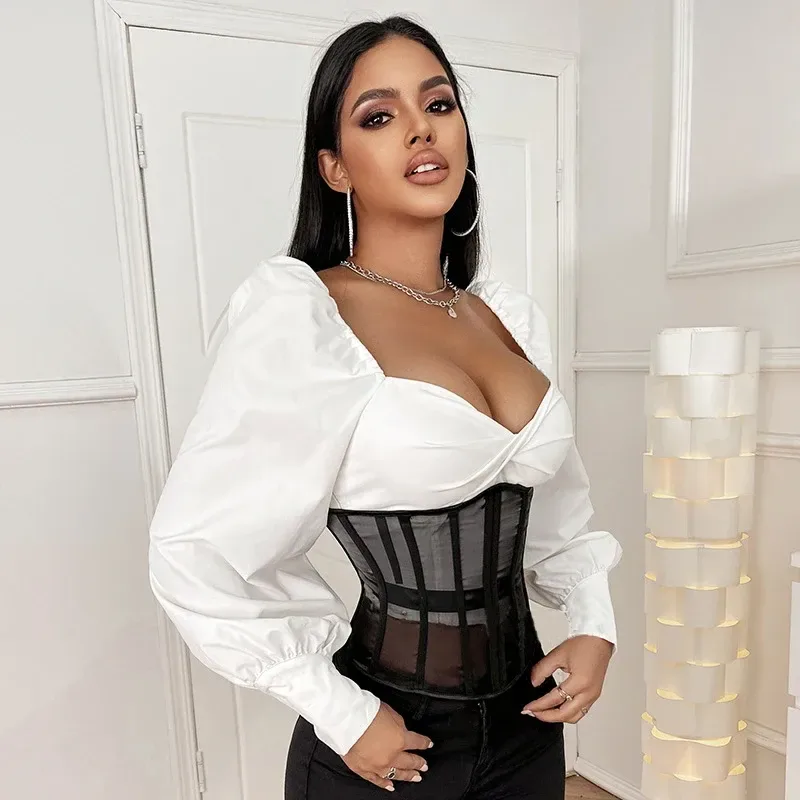 Mesh corset defining the waist over a white top